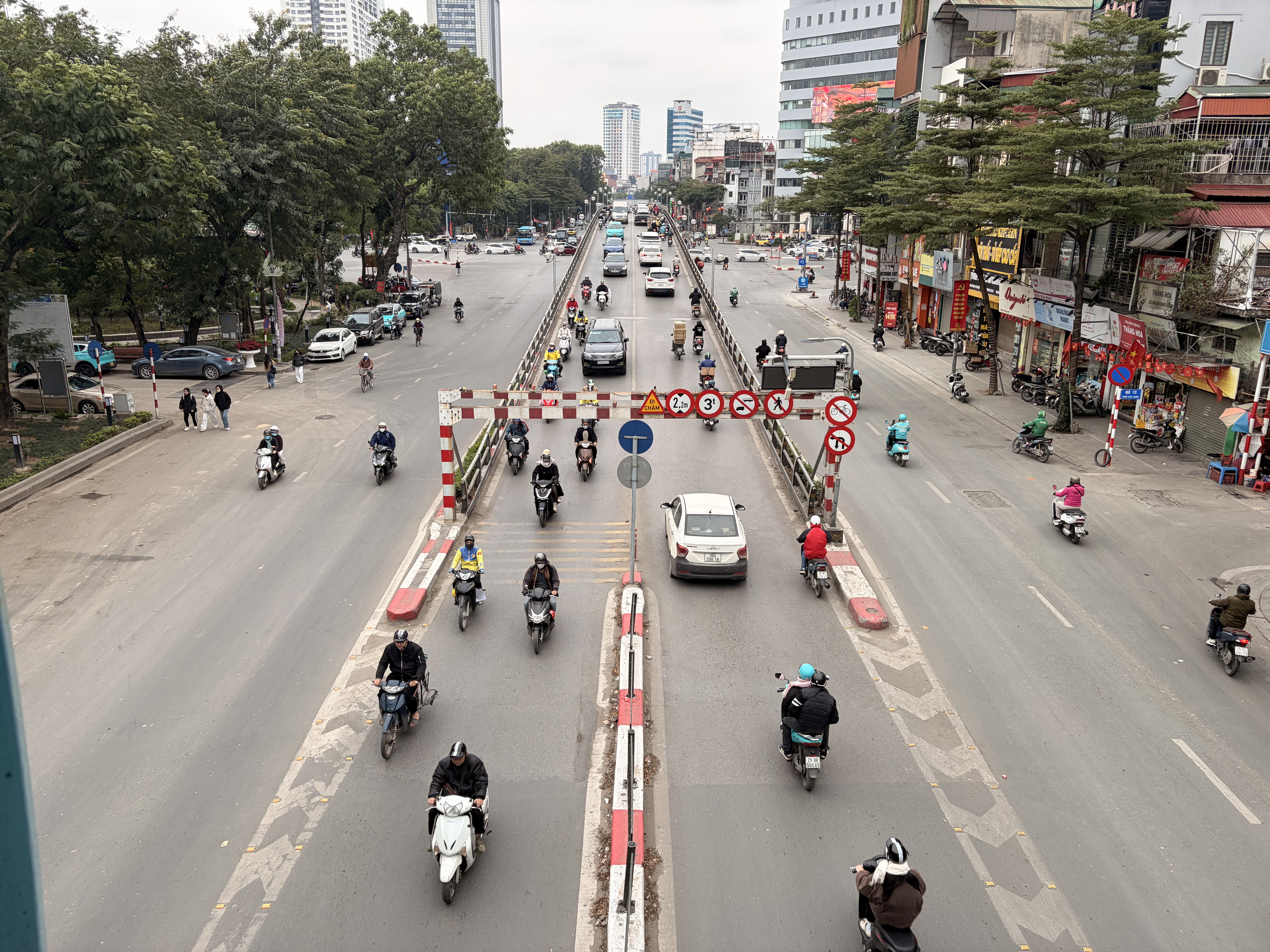 Aerial view of Hanoi intersection with motorbikes and lane dividers